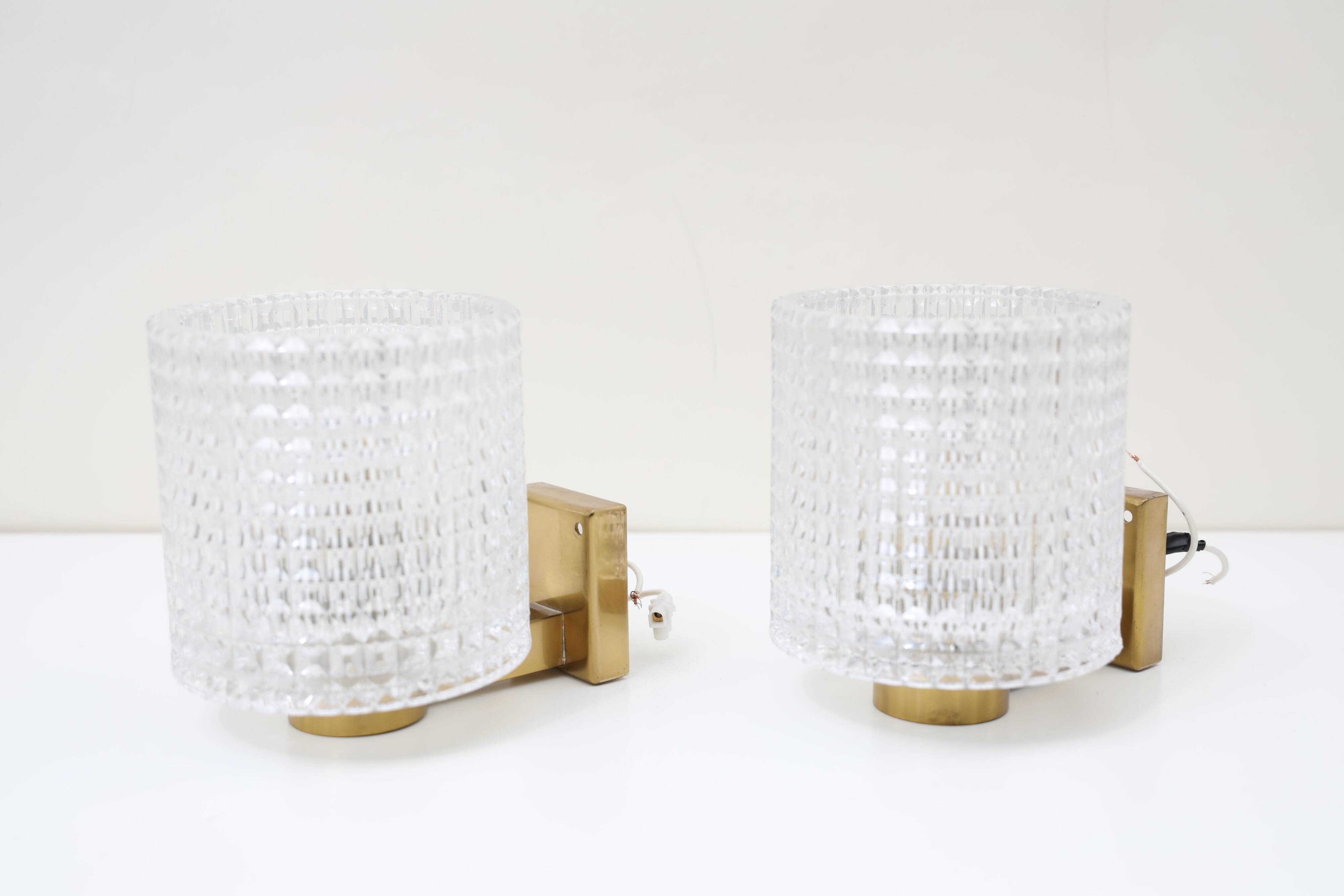 Carl Fagerlund for Orrefors Pair of wall lights in brass and glass Sweden 1960