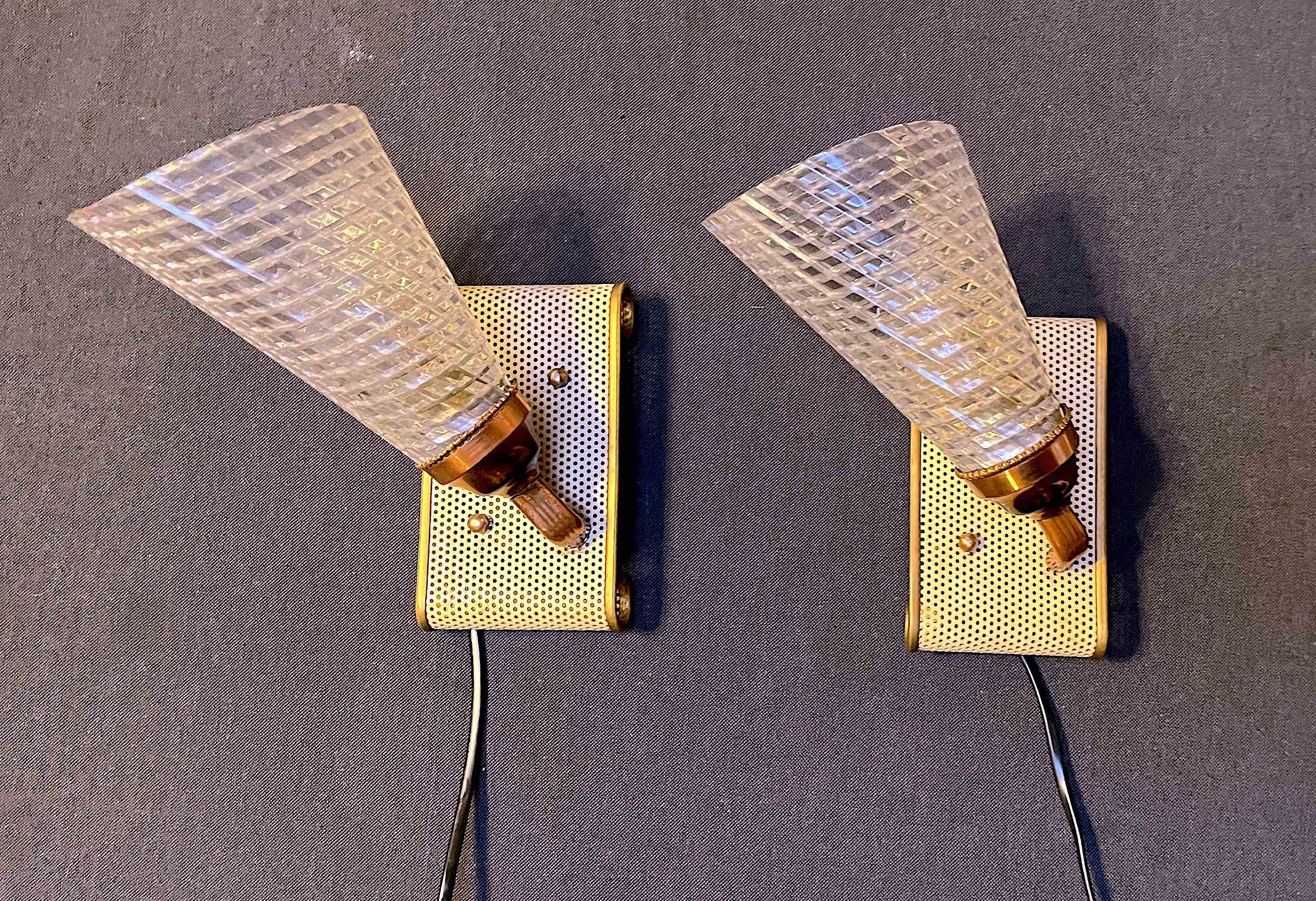 Pair of brass sconces, perforated metal and perhapx conical lampshade, France 50's
