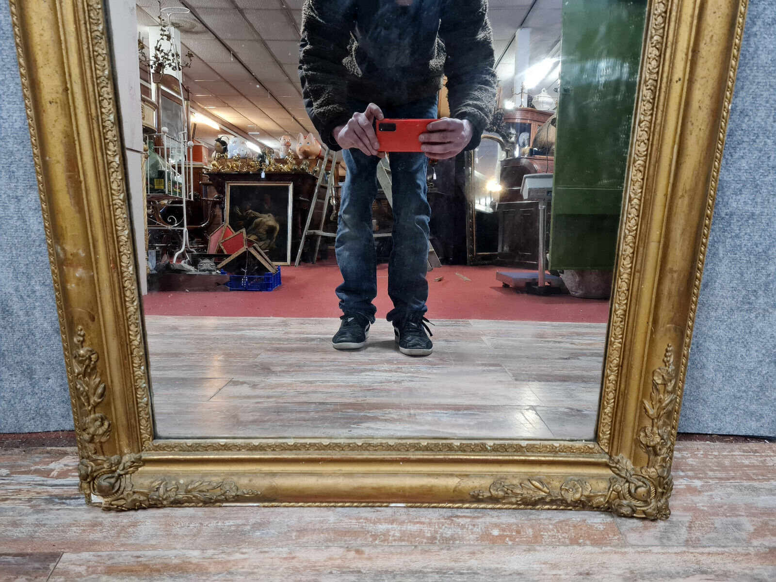 Old nineteenth century mirror in gilded wood and carved around 1850