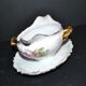 Vintage pouring sauce boat in floral porcelain with gilding.