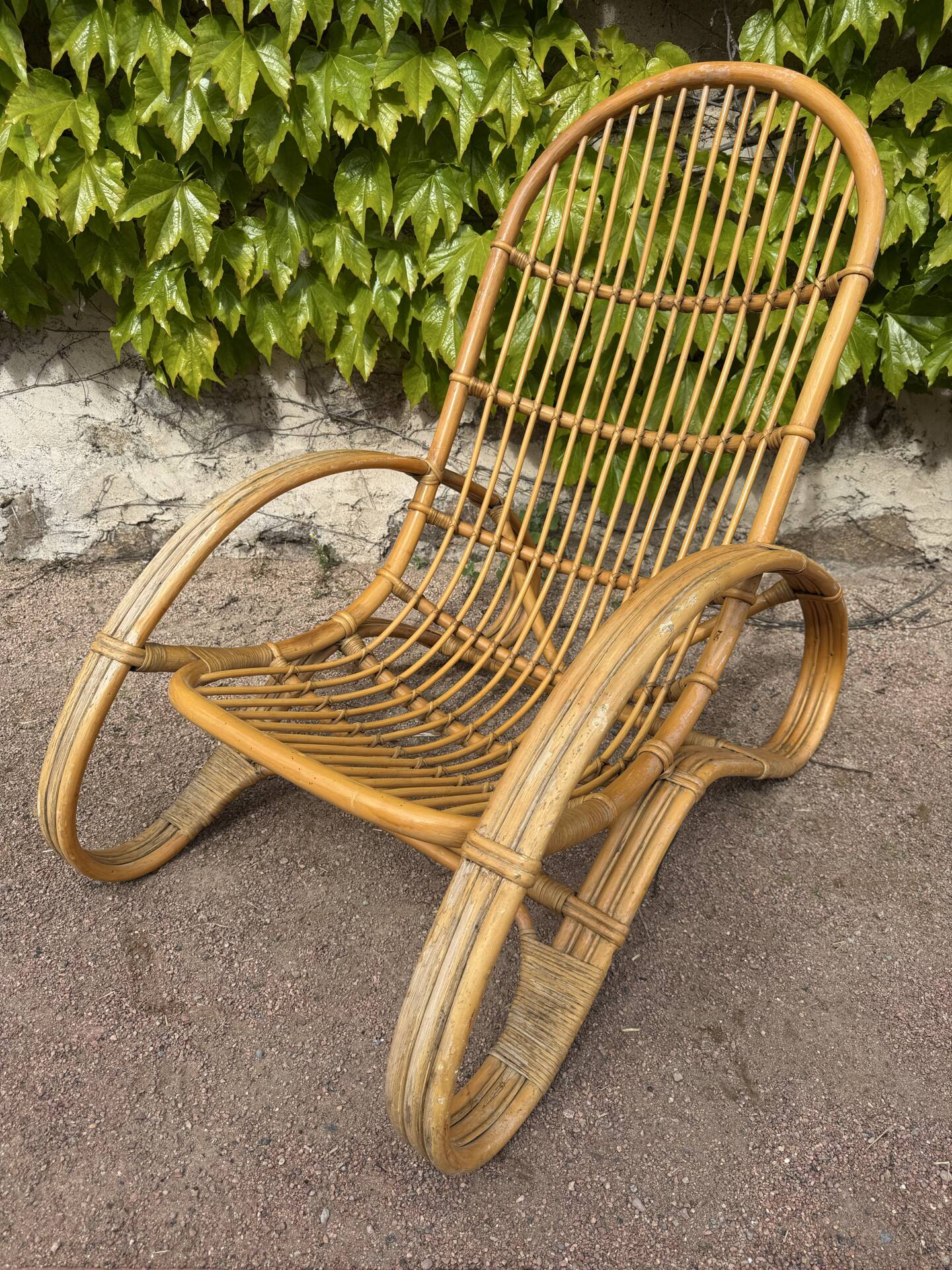 Curved bamboo and rattan armchair in Italian style by Roberti from the 1960s.