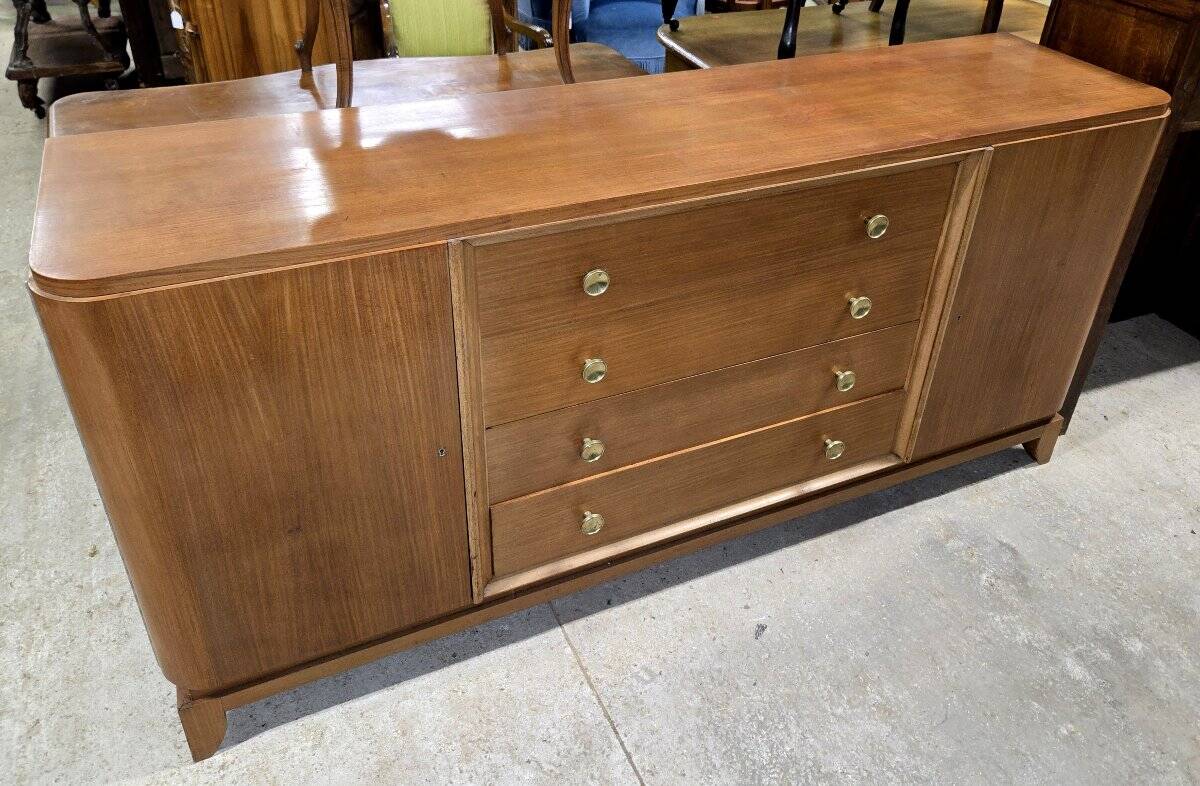 According to André Arbus, a sideboard in a row from the Art Deco period in blonde mahogany.