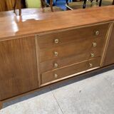 According to André Arbus, a sideboard in a row from the Art Deco period in blonde mahogany.