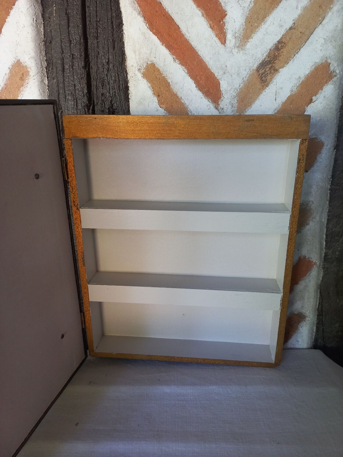 Golden frame secret shelf