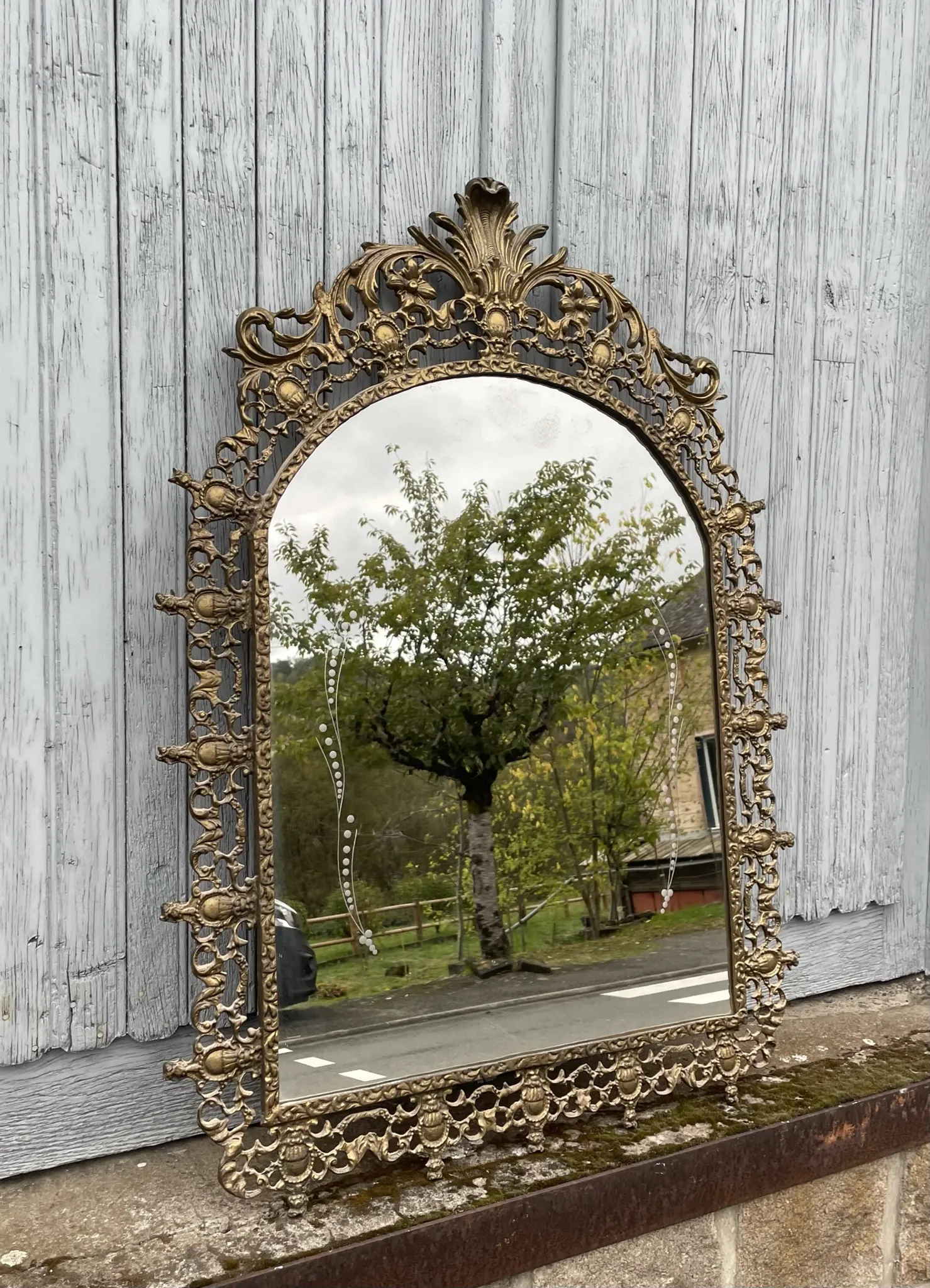 Vintage brass wall mirror adorned