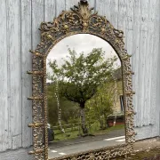 Vintage brass wall mirror adorned