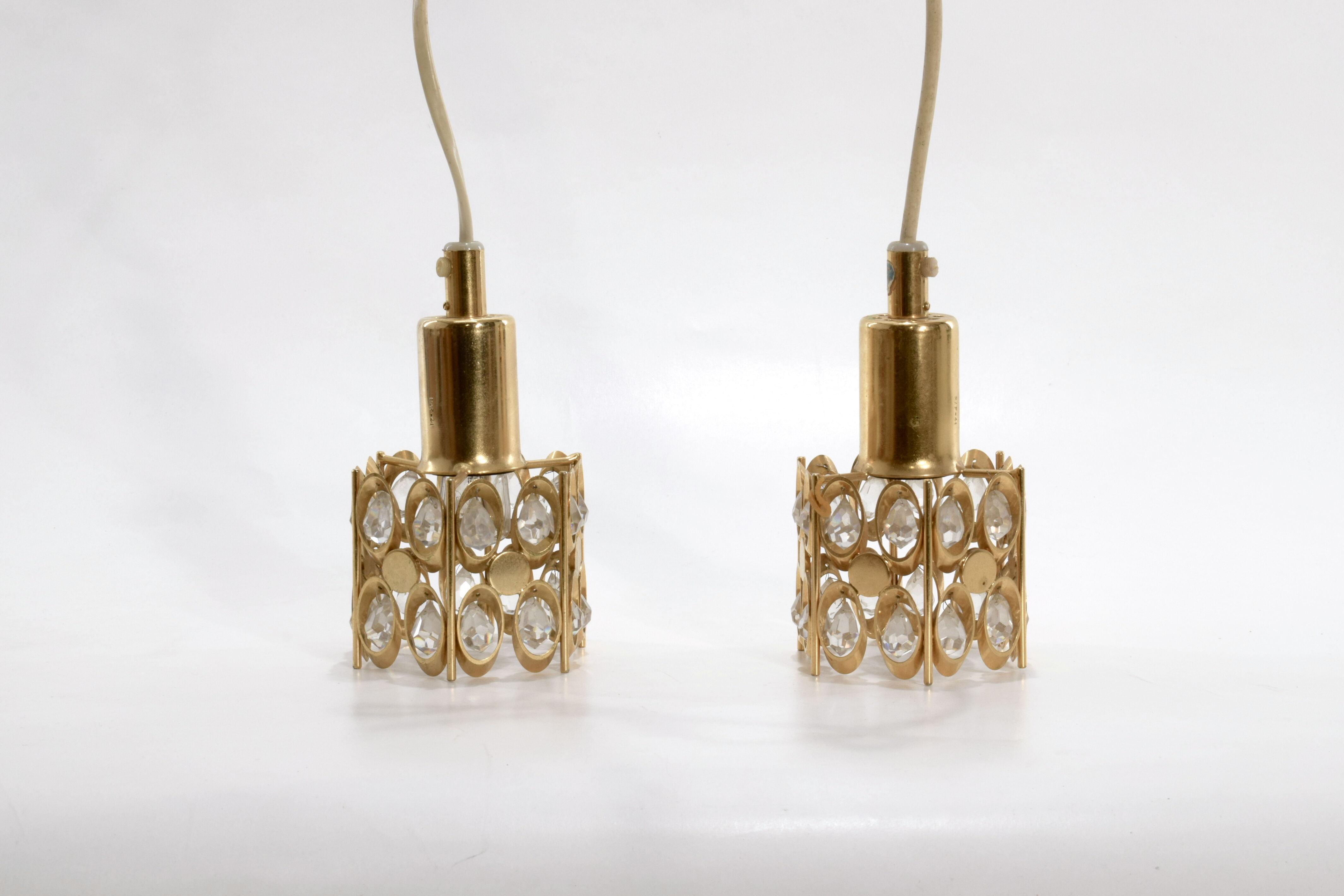Two pendant lights in gilded brass and crystal, by Palwa, design 1960