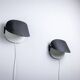 Matte black wall lamps with perforated shades and brass details