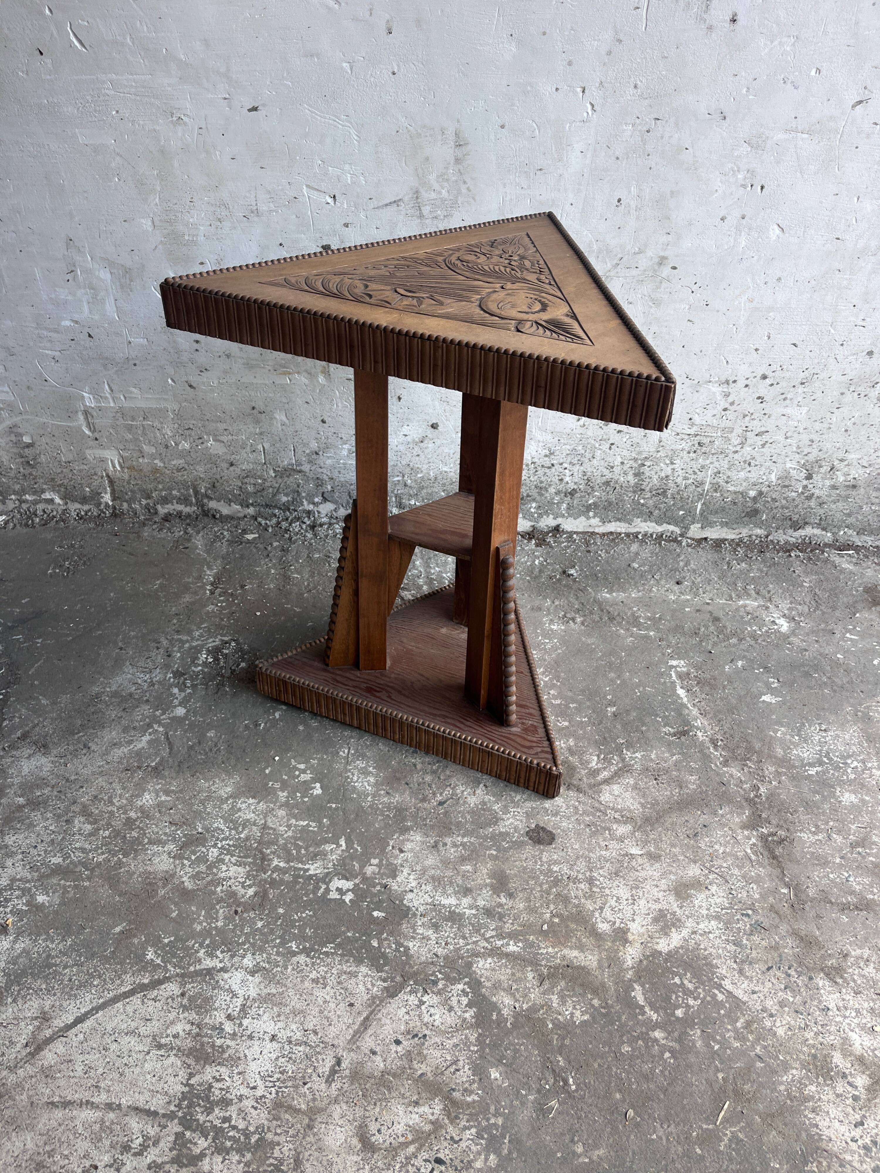 Triangular side table in carved wood, Art Nouveau, France, circa 1915.