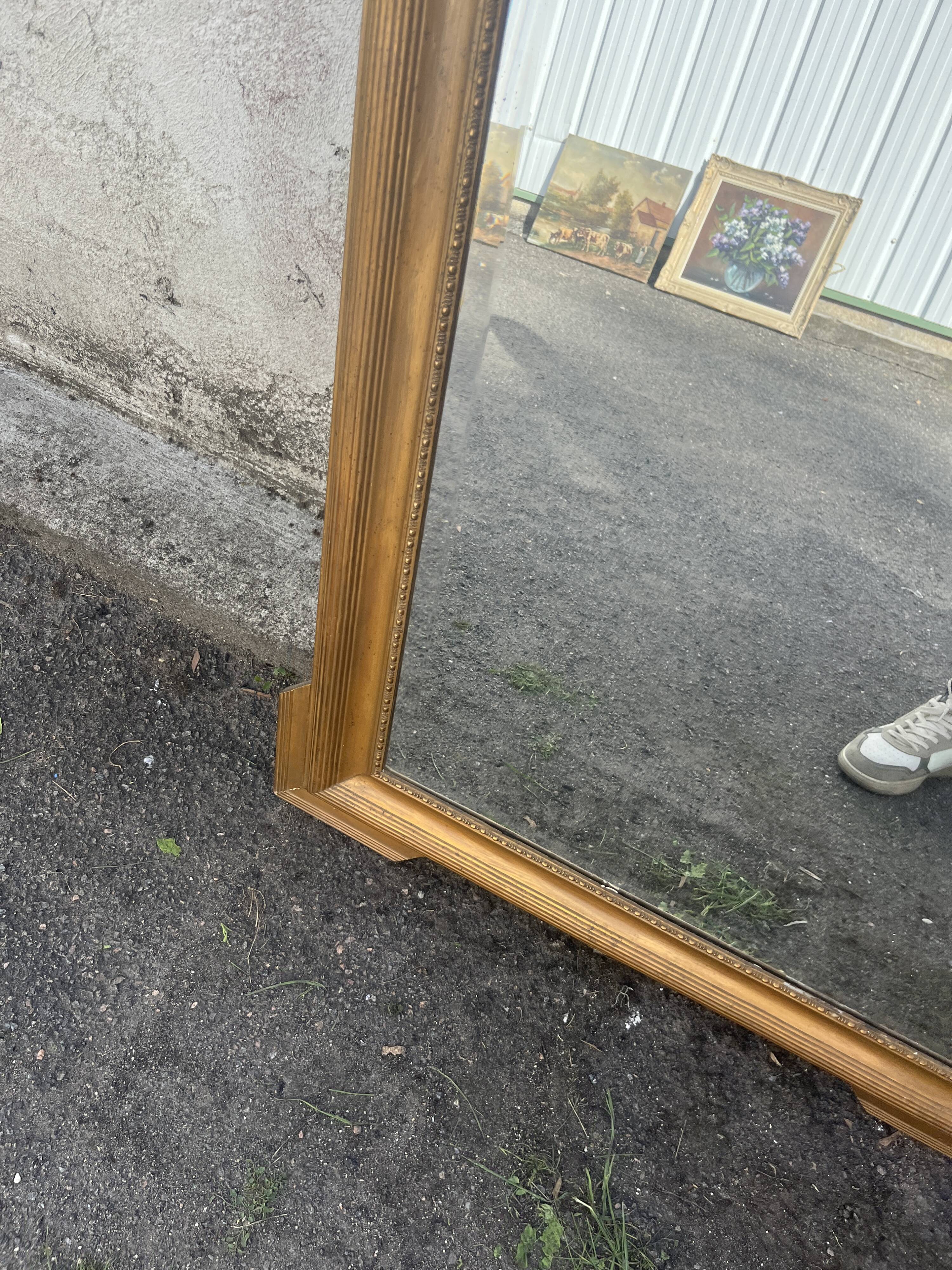 Large antique gilded mirror with carved pediment, 126 cm