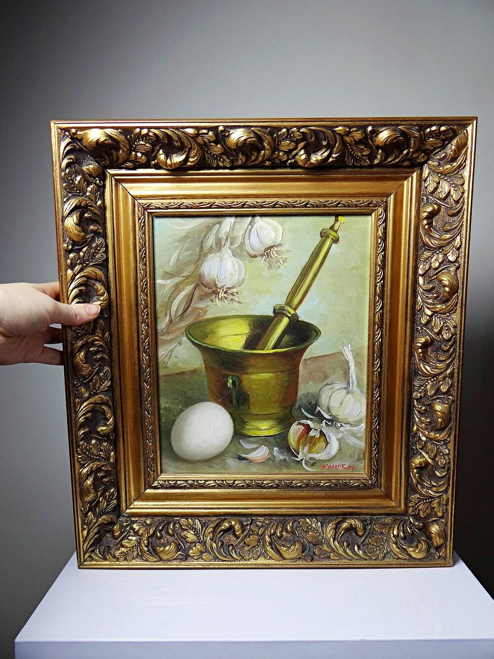 Still life with garlic, egg, and mortar signed Sarpe, 1979, oil on canvas.