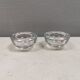 A set of iittala candle holders in clear transparent glass.