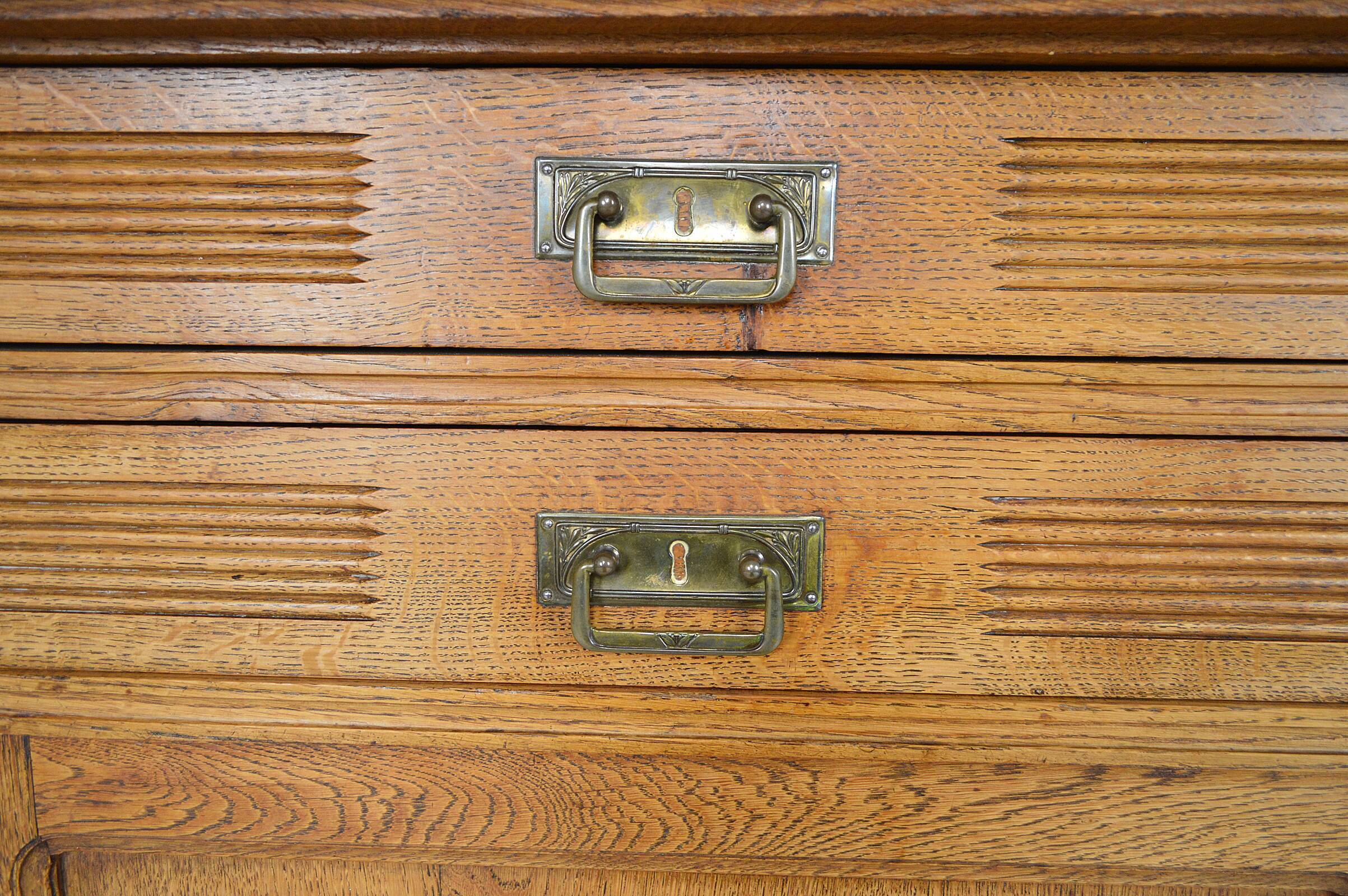 Art Nouveau oak buffet and dinanderie panels, circa 1910