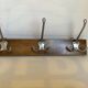 Old coat rack wood metal three hooks