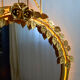 Vintage round illuminated mirror in gold metal with rose decoration.