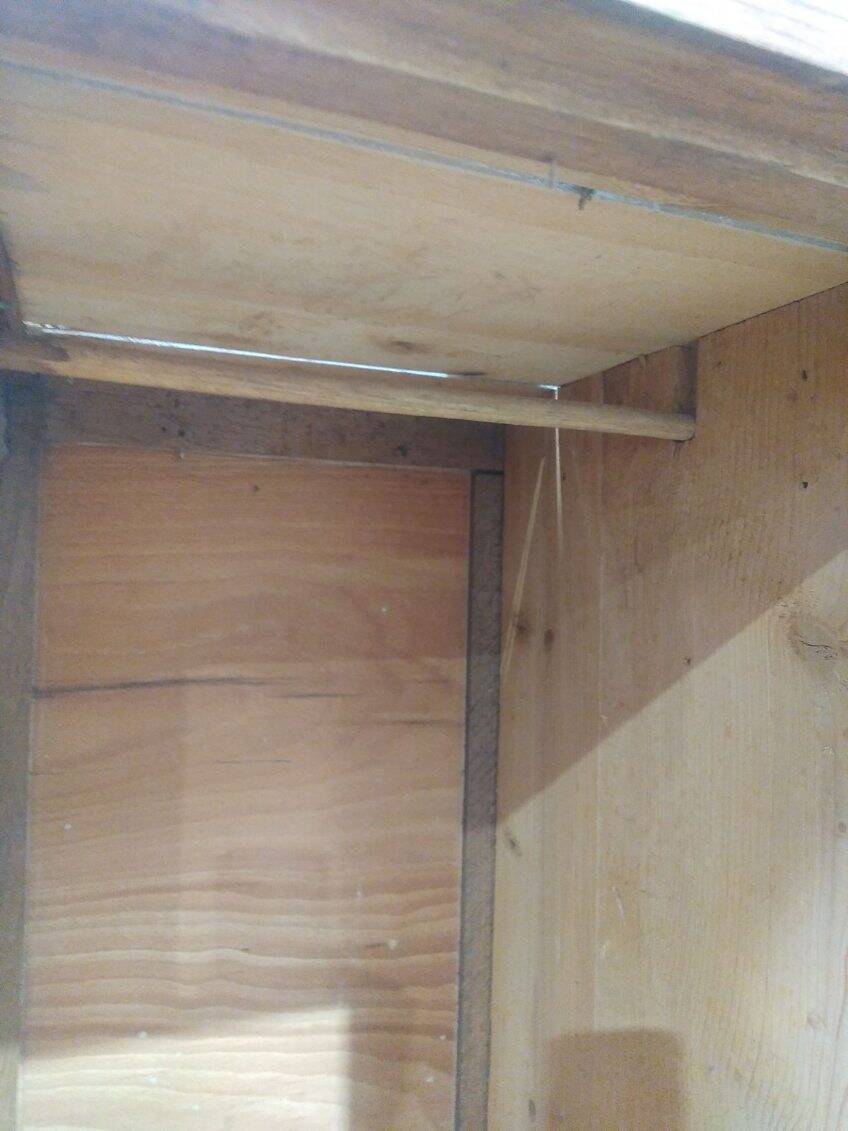 Vintage wooden wardrobe with matte cast iron color hanging rail