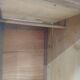 Vintage wooden wardrobe with matte cast iron color hanging rail