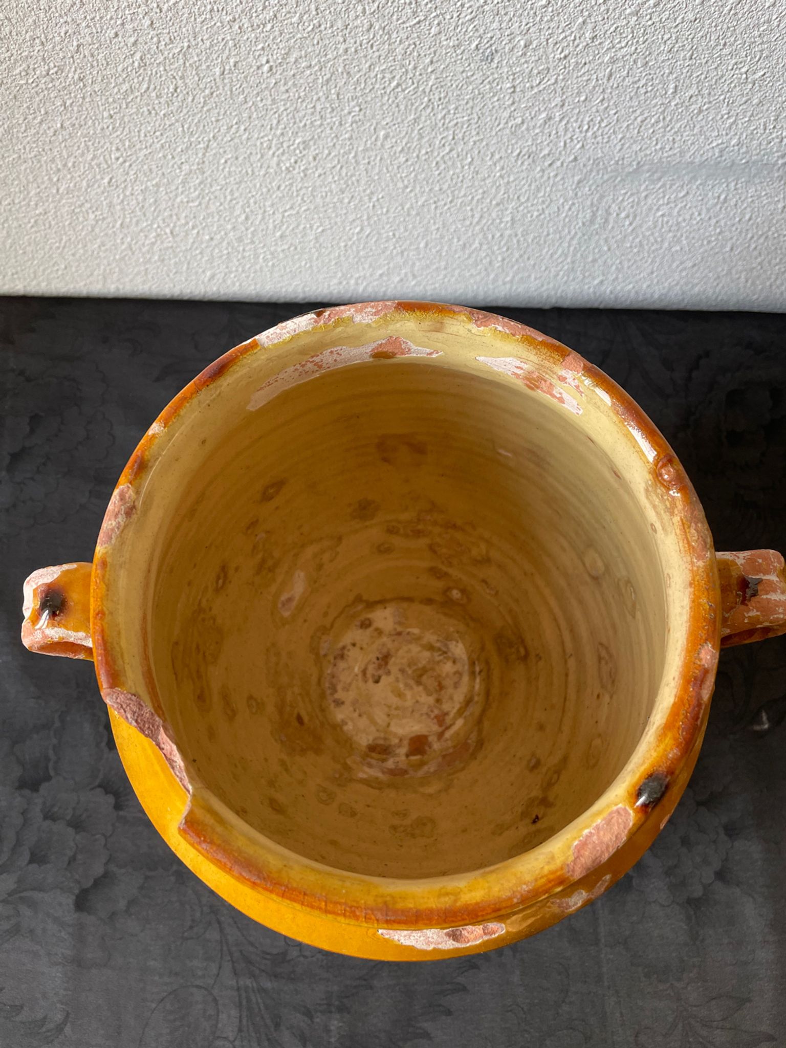 Old grease pot in glazed yellow terracotta, France nineteenth century