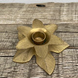 Old golden brass candle holder in the shape of a leaf or flower