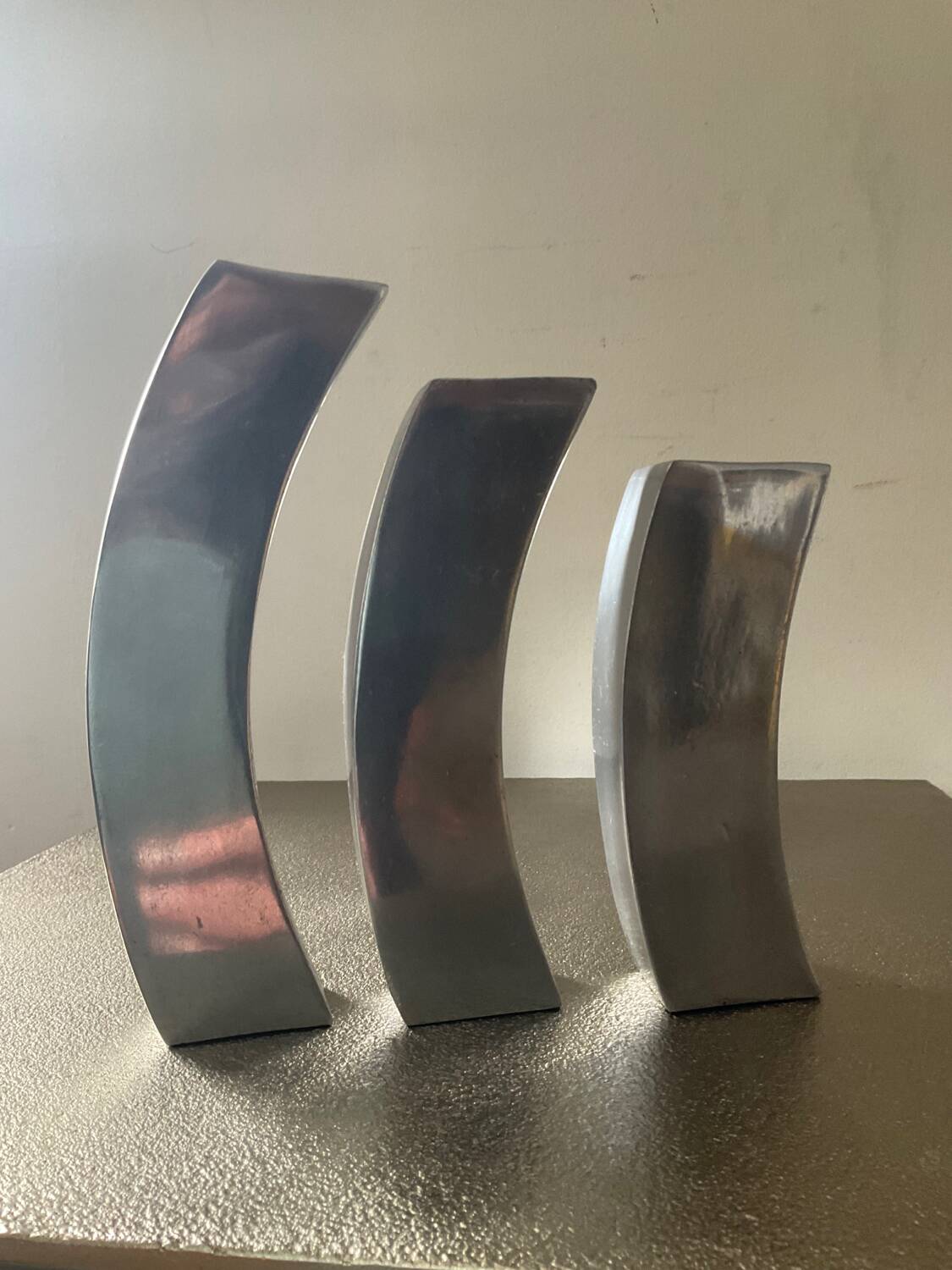 Trio of cast aluminum candle holders
