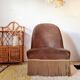 Brown velvet crapaud armchair with fringes and sculpted legs.