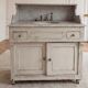 Antique wooden bathroom cabinet with painted finish and white marble.