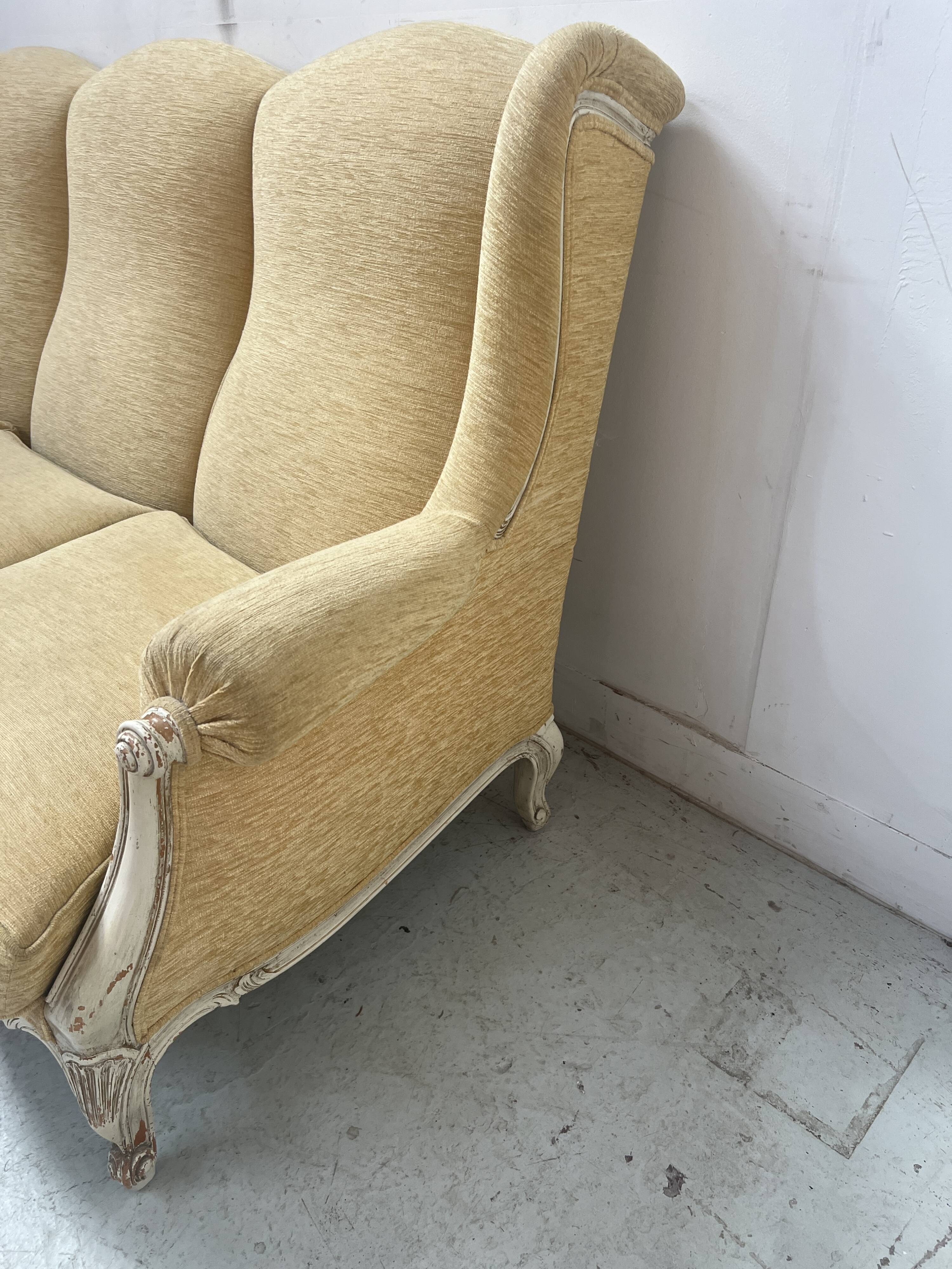 Louis XV style three-seater wingback sofa in patinated beech, 20th century