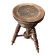Adjustable brown leather piano stool with turned legs, produced in the 1940s.