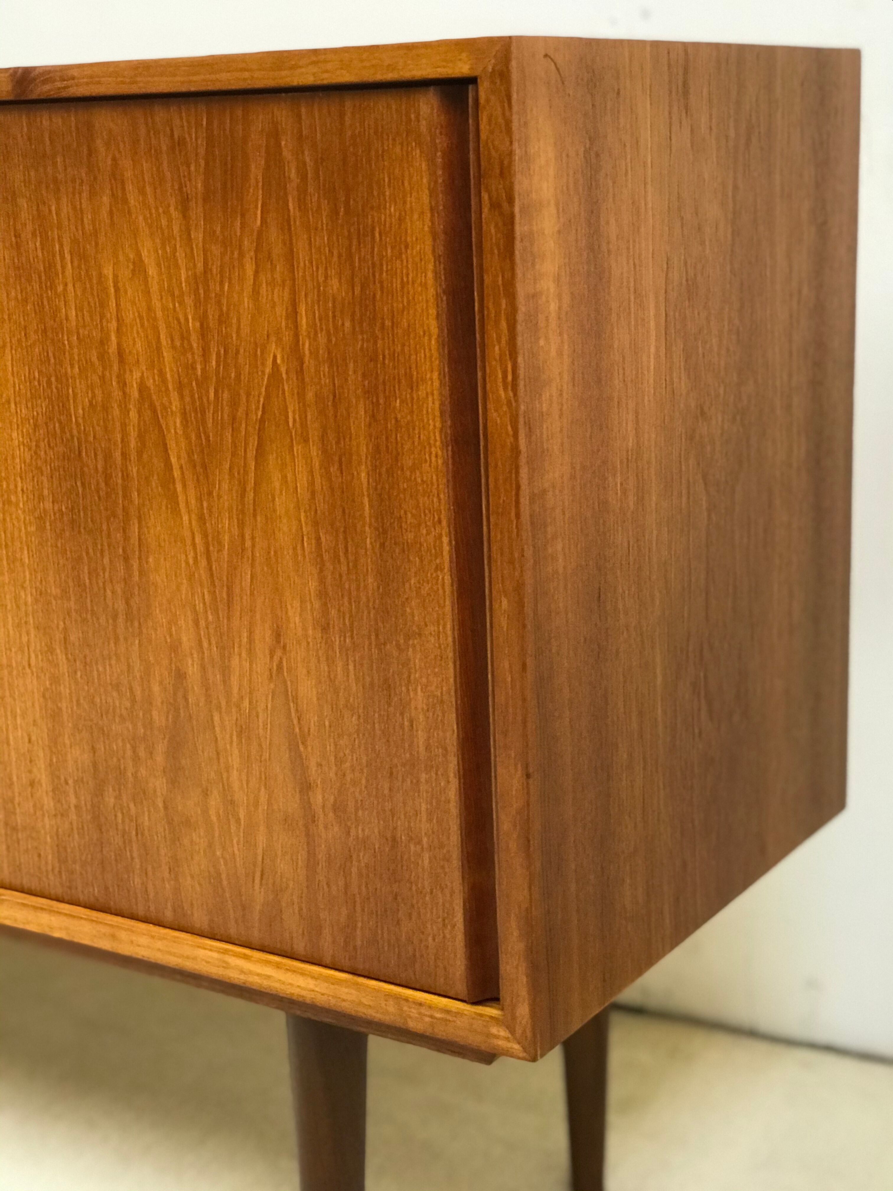 Danish teak sideboard with two sliding doors and 4 central drawers