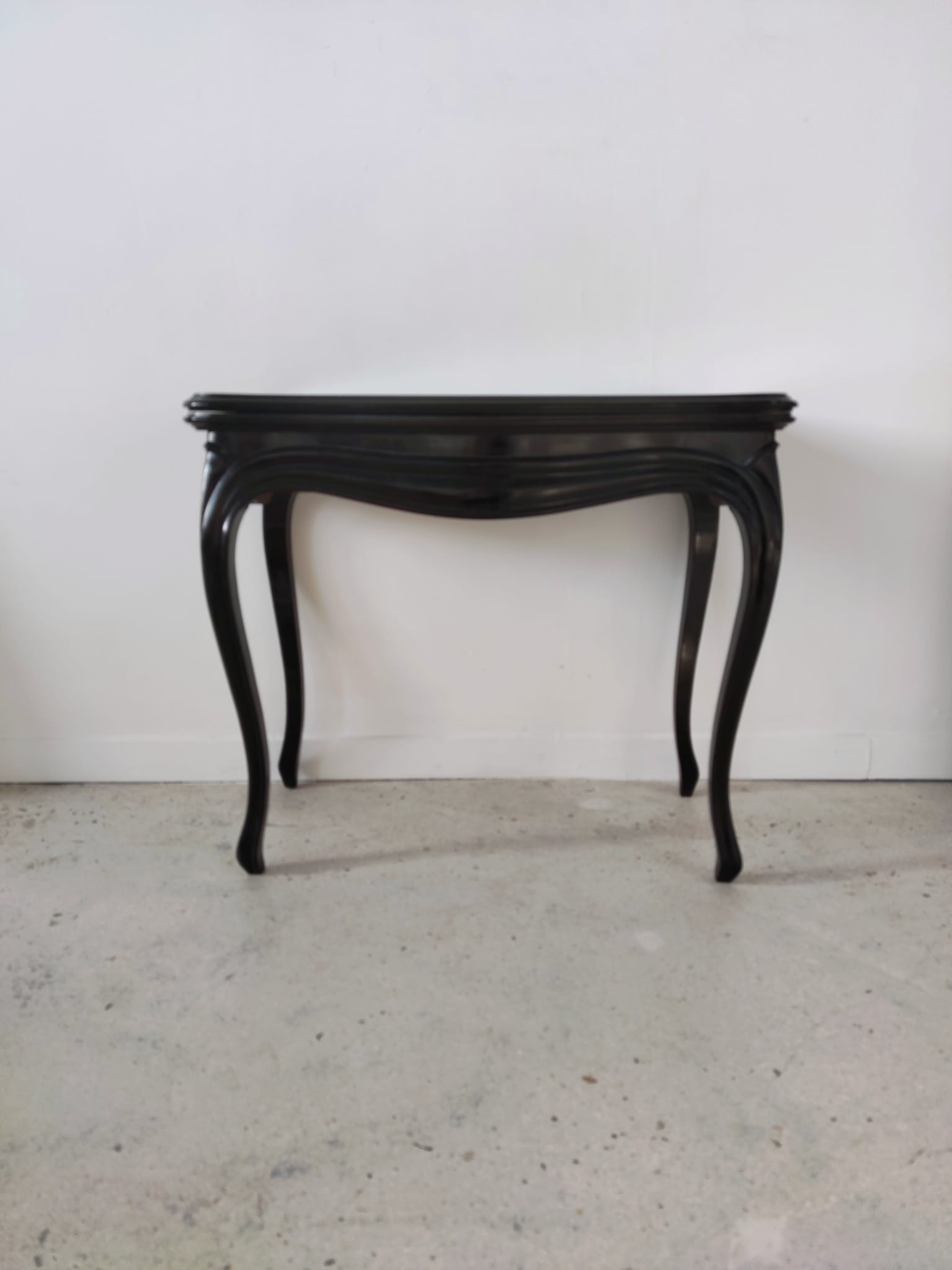 Molded blackened wooden play table, arched legs, green felt