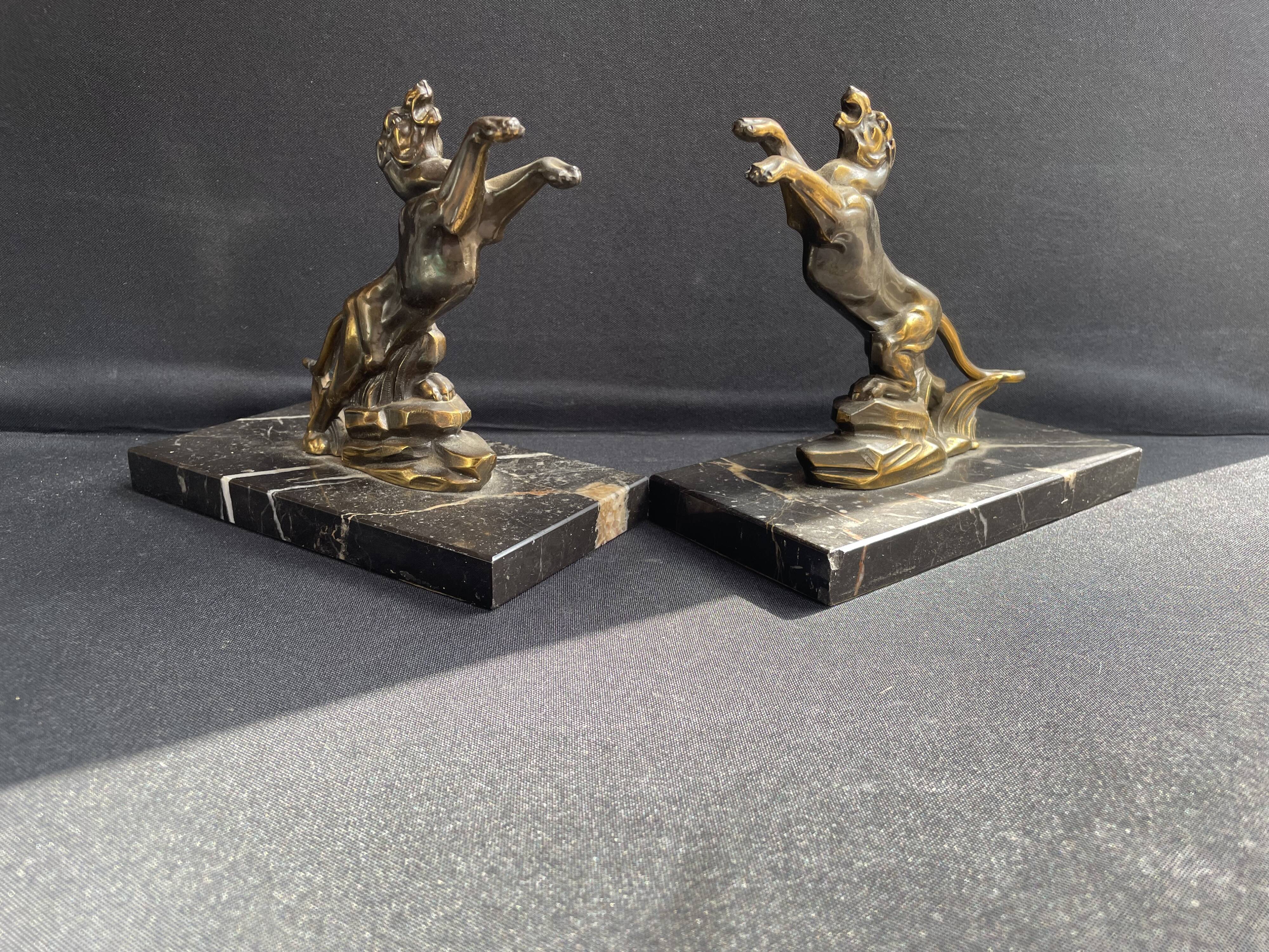 Pair of art deco marble and patinated regulated bookends