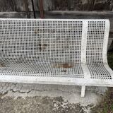 Old perforated metal garden bench