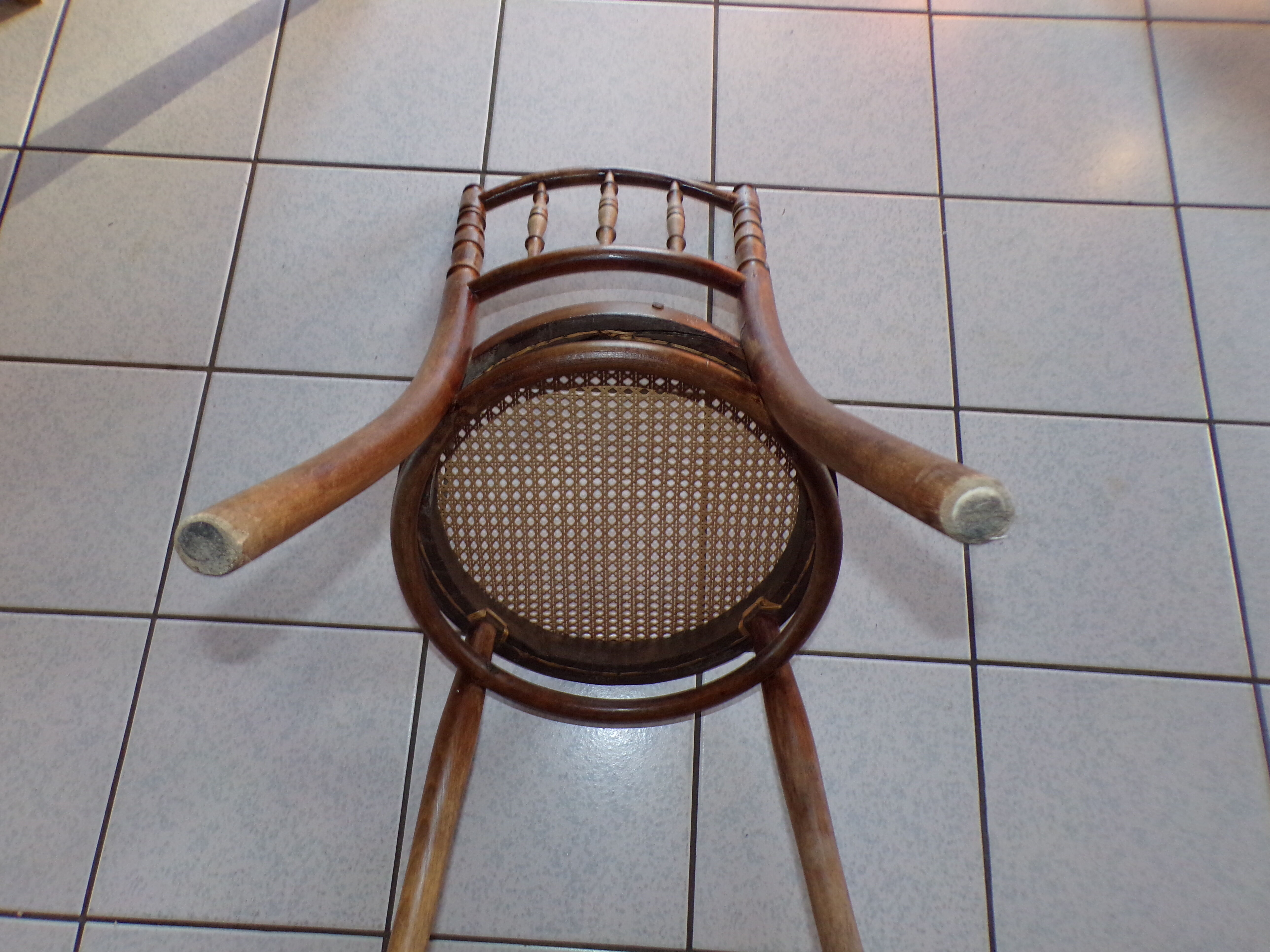 Curved wooden chair, turned and seated in cannage