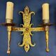 Pair of electrified golden wrought iron gothic wall sconces.