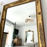 Antique gilded mirror from the Restoration period, 19th century.