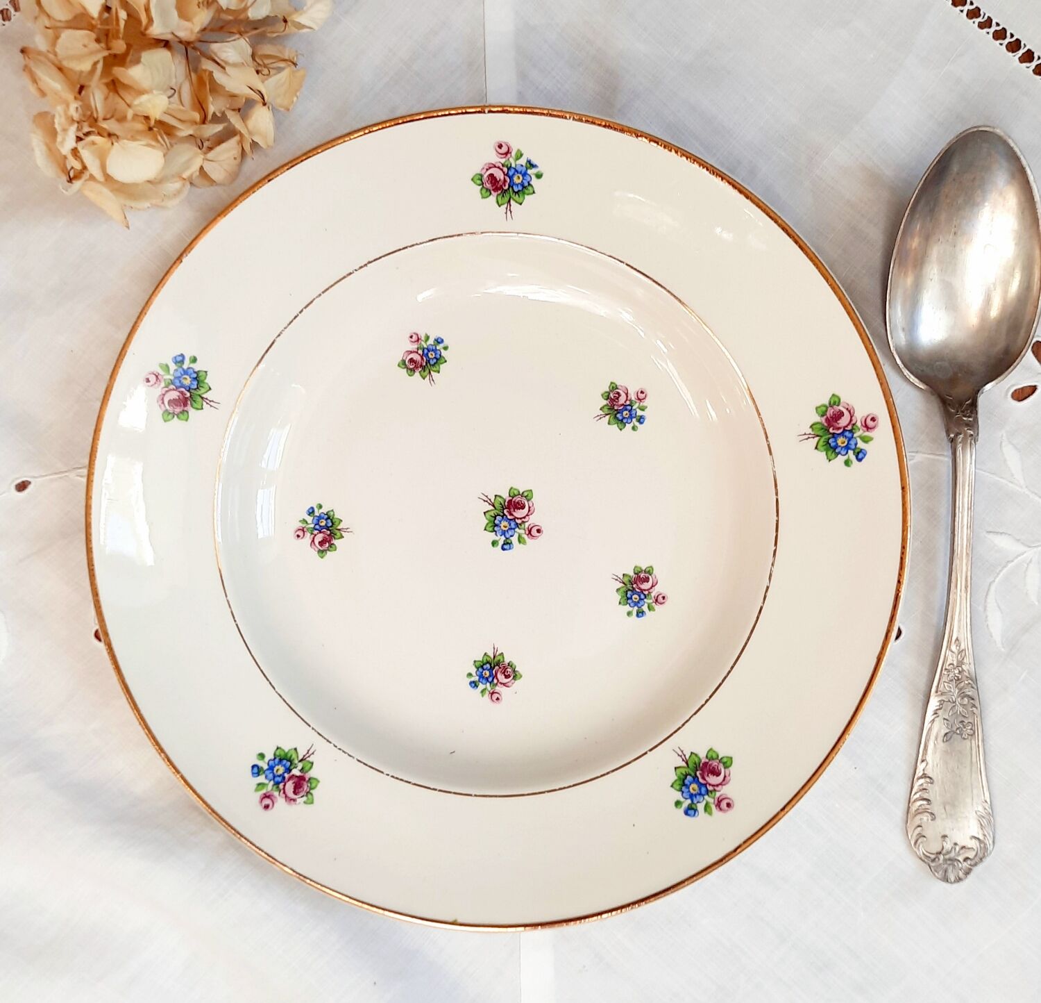 Old hollow plates mismatched in earthenware with gilded edges