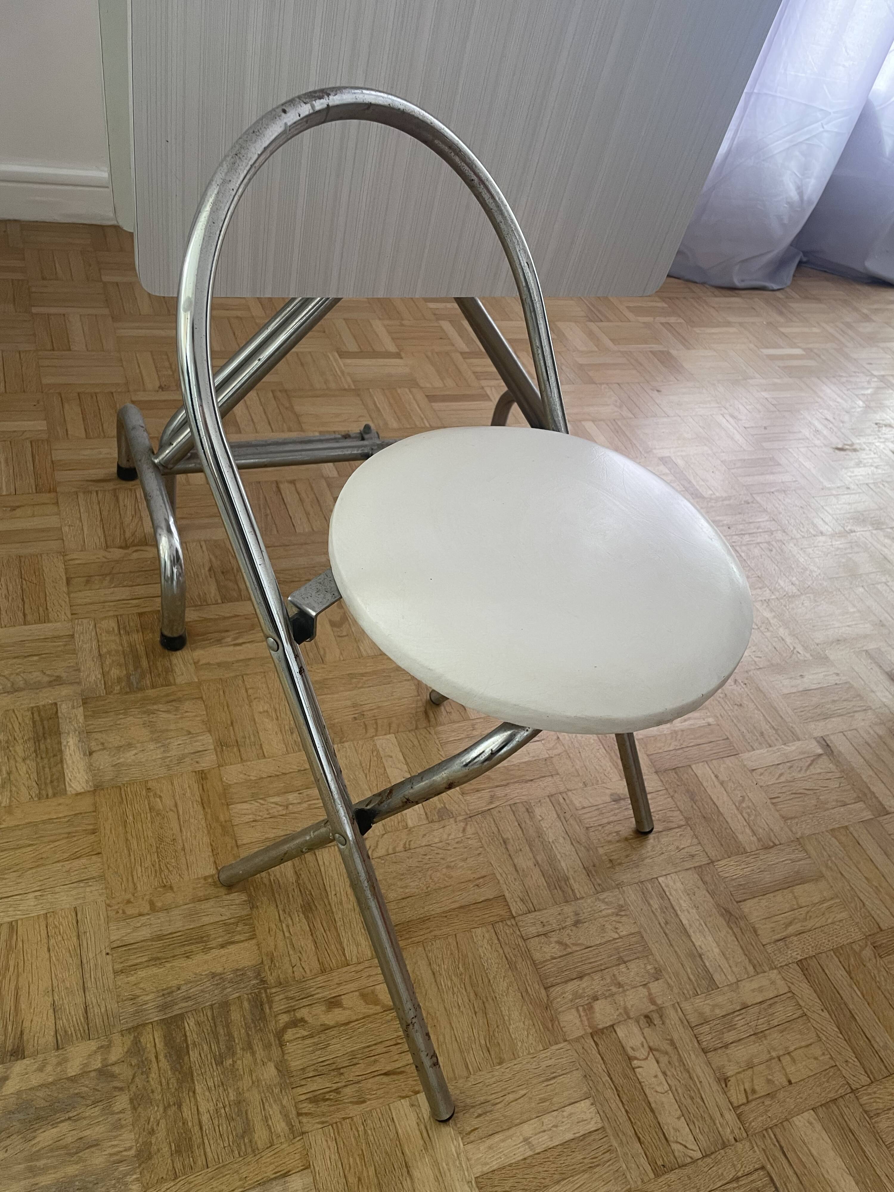 Small stools in metal and faux leather.