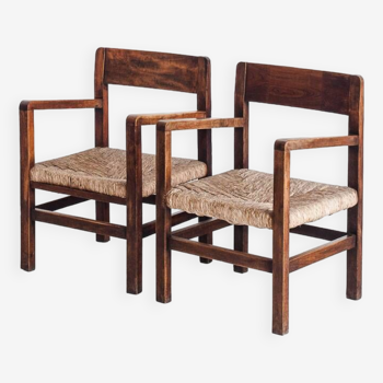 Paire de fauteuils rustiques en bois massif et assises en paille. France, années 1940