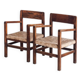 Paire de fauteuils rustiques en bois massif et assises en paille. France, années 1940