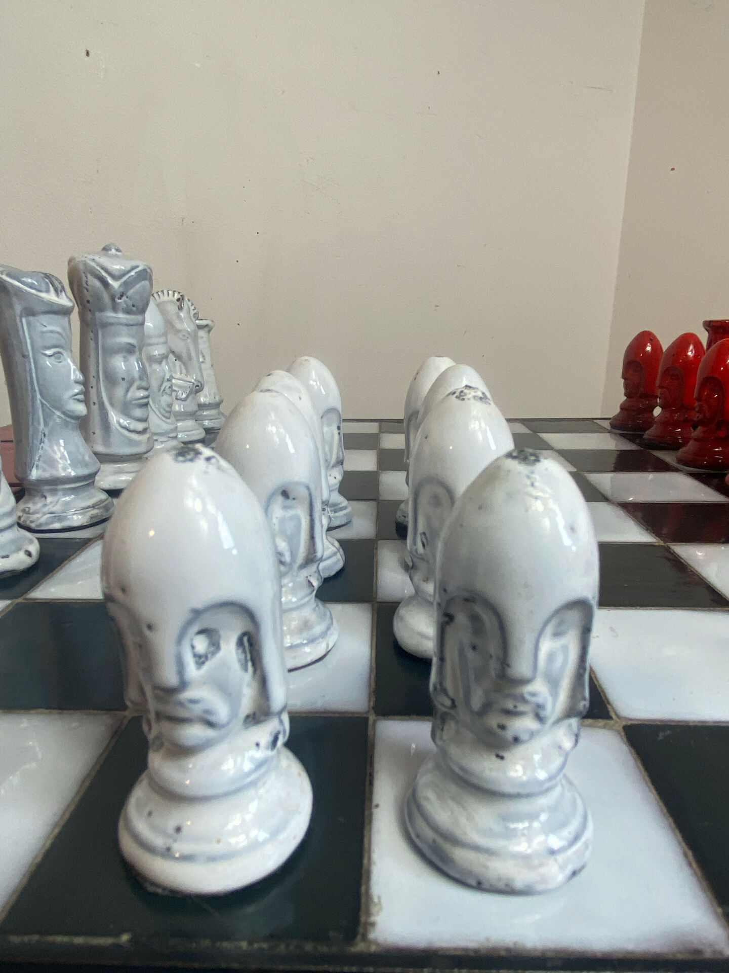Chess set with ceramic board and pieces.