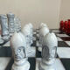 Chess set with ceramic board and pieces.