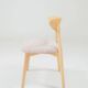 Set of 6 pale pink dining chairs in natural wood.
