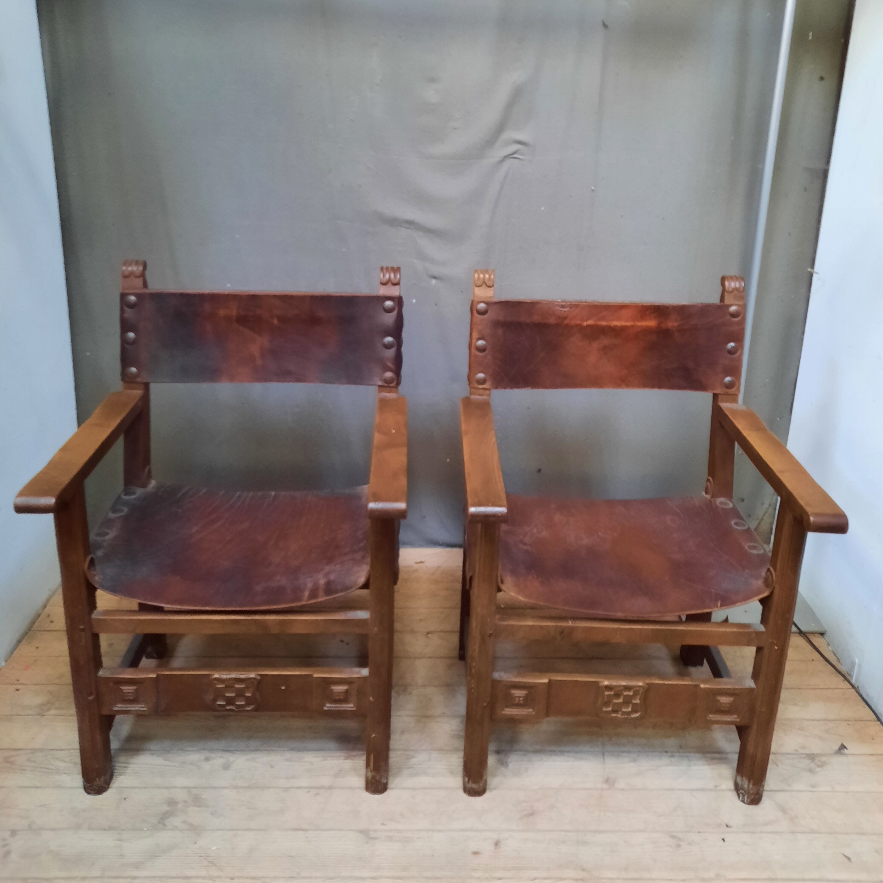 Pair of medieval leather style armchairs