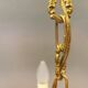 Older brass alloy chandelier with three light sources.