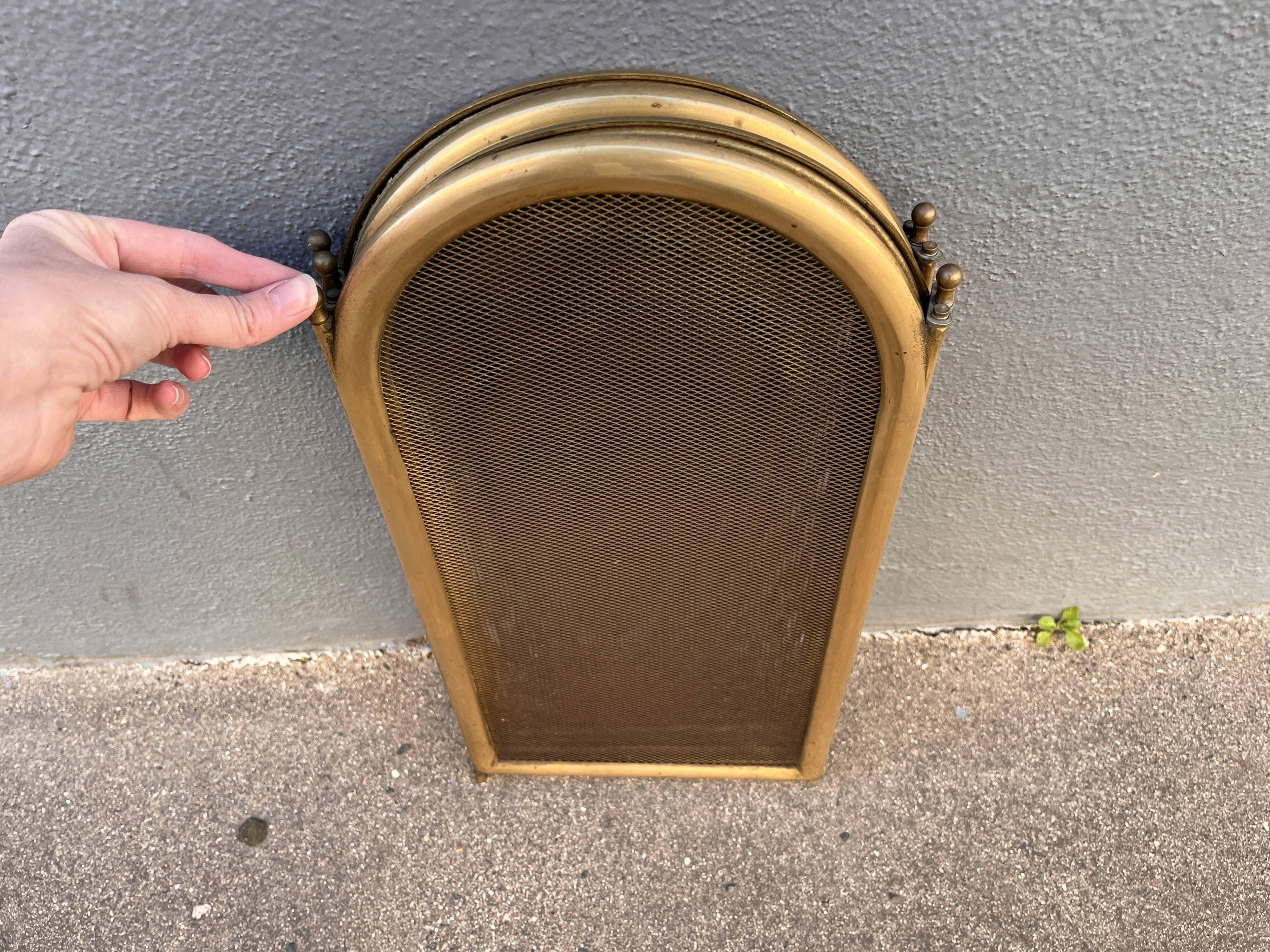 Antique brass fireplace screen from 1920, vintage spark guard.