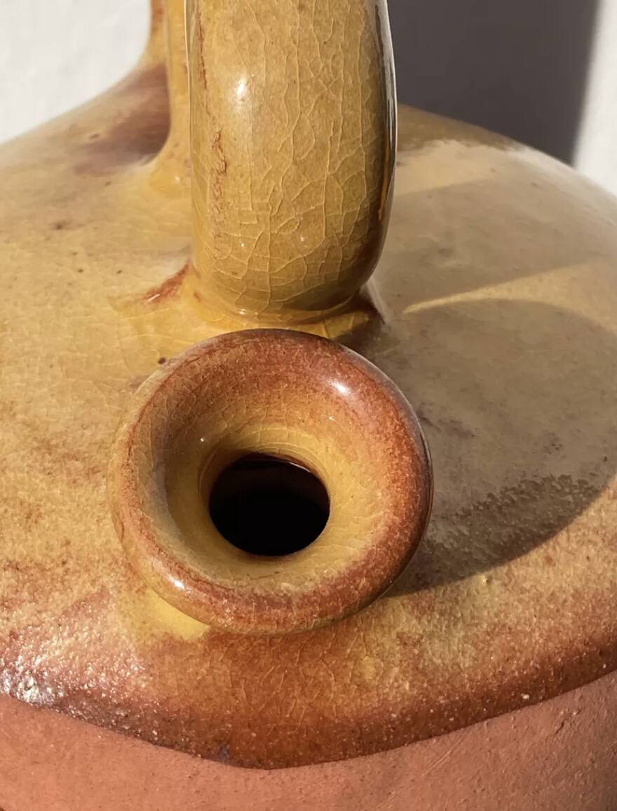 Gargoulette or old jug in yellow glazed terracotta