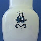 White-blue earthenware vase with stylized plant decoration
