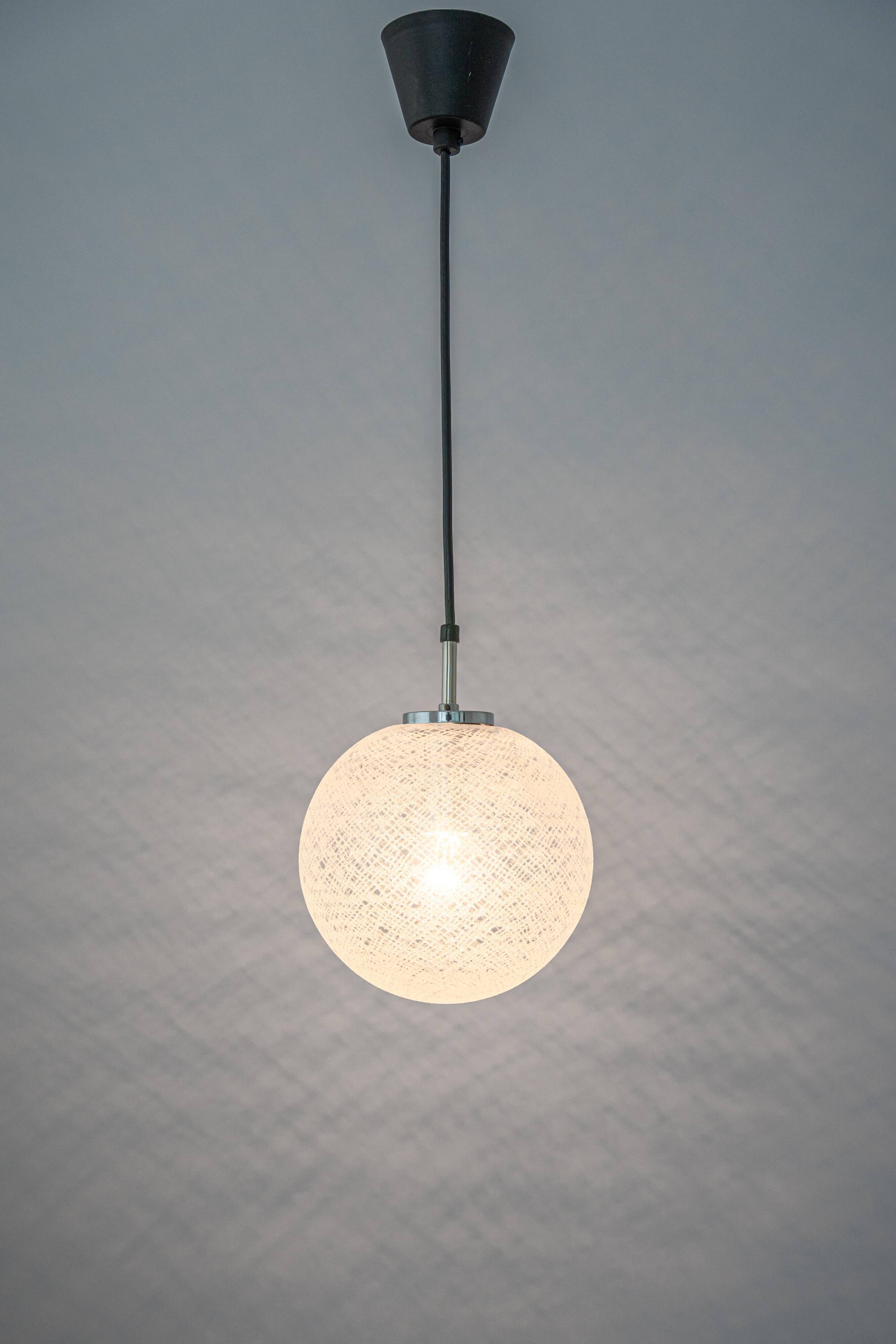 Small chrome Limburg pendant light with glass ball, Germany, 1970s.