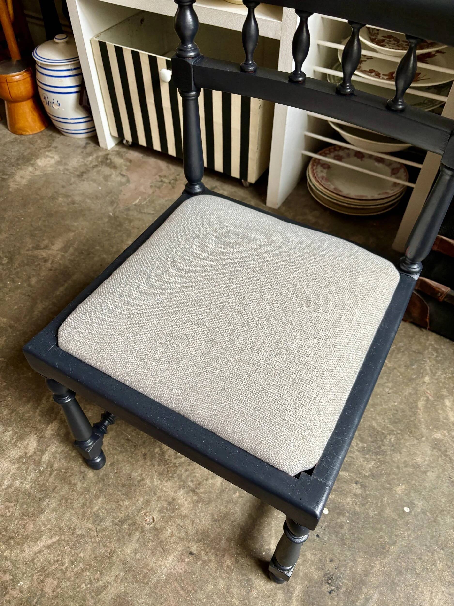 Black turned wooden chair and ivory cotton.