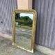 Large Louis Philippe mirror in carved gilded wood with mercury glass.